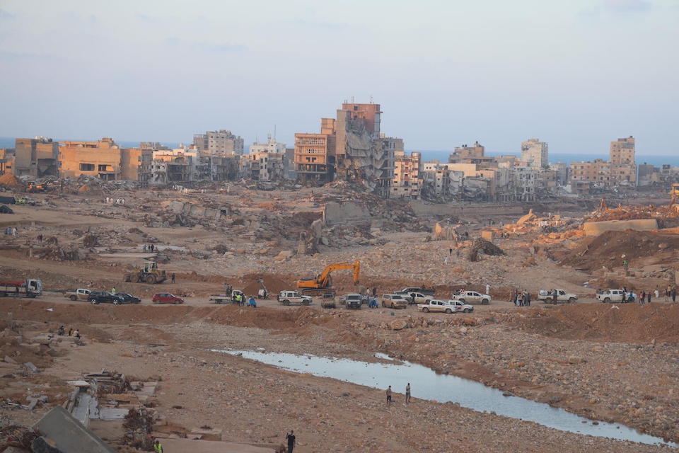 On Sept. 16,  2023,  a convoy of cars and ambulance vehicles navigates through the devastated city centre of Derna in eastern Libya. 
