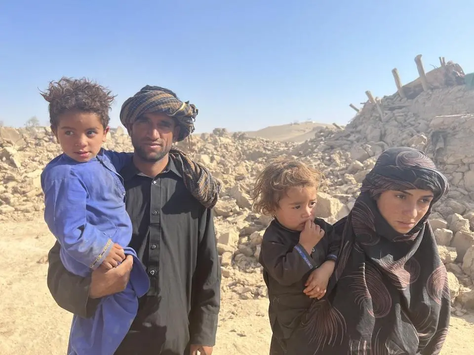 Bibi Jan, far right, and her family were sleeping outside in makeshift tents when a third earthquake shook Chahak village in the Enjil district of Herat province, destroying all 700 homes.
