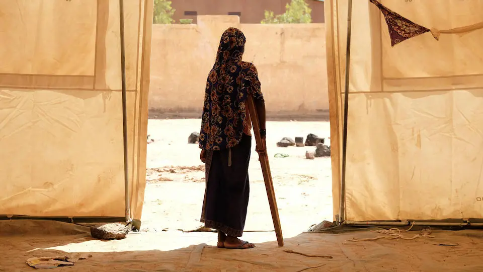 Aminata of Ogossagou, wounded as she fled her village during an attack, uses a crutch to walk around a UNICEF-supported displacement camp in Sévaré.