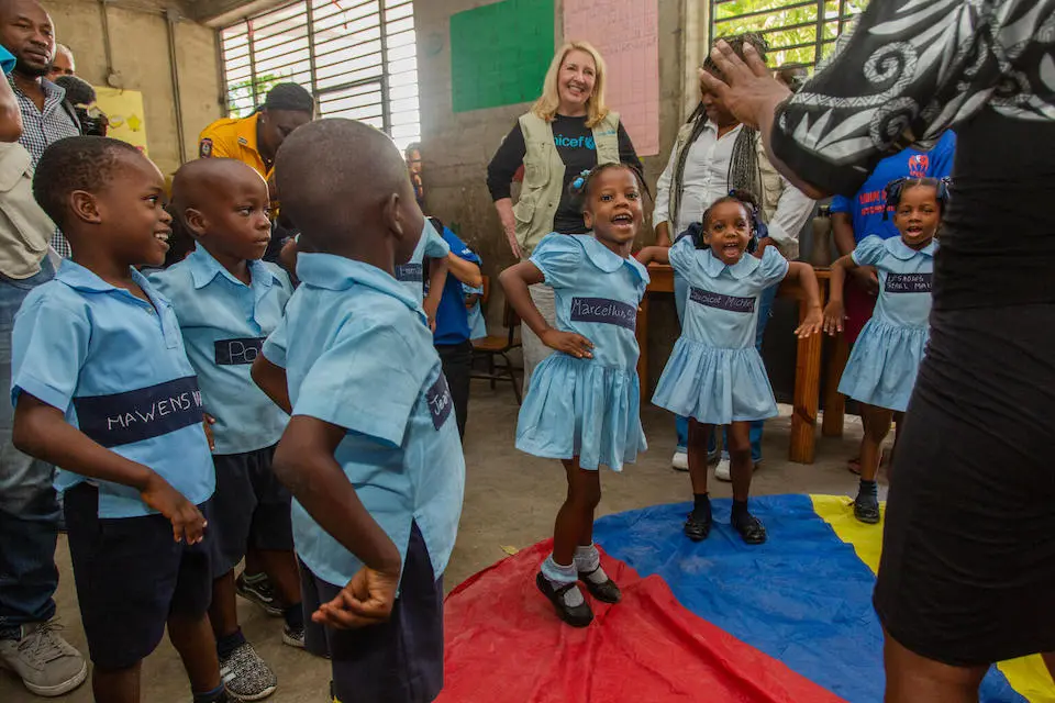 School children sing and dance at a UNICEF-supported school in Port-au-Prince, Haiti.
