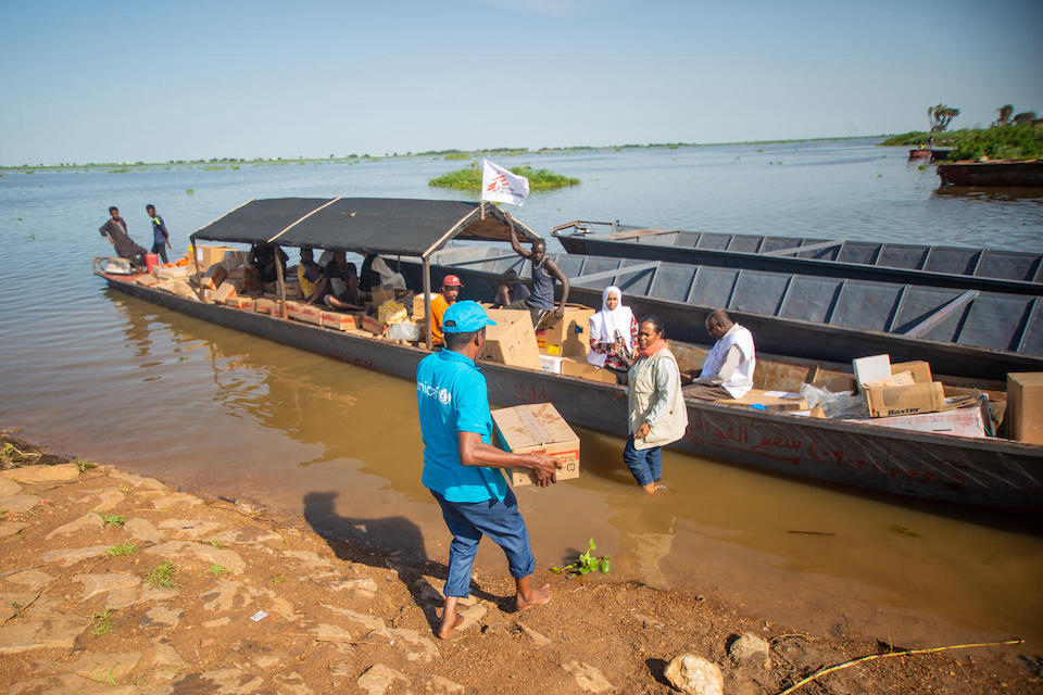 UNICEF staff and partners load health supplies including vaccines onto a boat to take to a remote location in White Nile state, Sudan, where cases of measles and malnutrition have been on the rise.