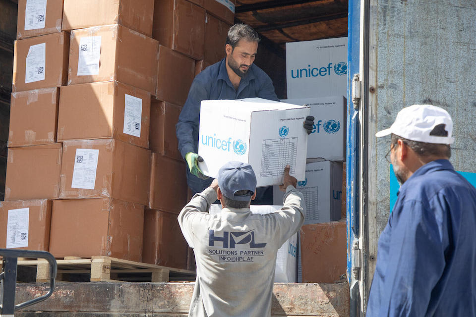 On Oct. 8, 2023, UNICEF workers load cartons of family hygiene kits into a truck for distribution to those affected by the Oct. 7 earthquake in western Afghanistan. 