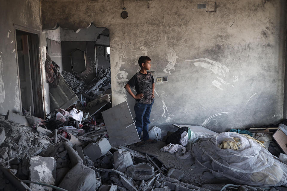 A Palestinian child at his house that was destroyed by air strikes on the city of Rafah in the southern Gaza Strip.