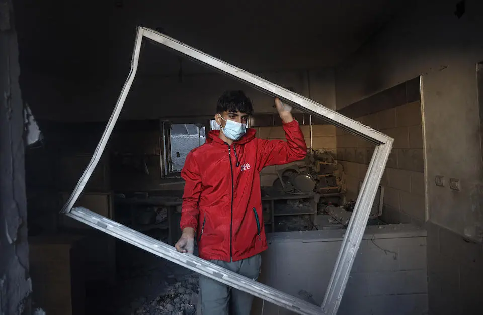 On Oct. 19, 2023, a boy surveys the damage of his home, destroyed by air strikes on the city of Rafah in southern Gaza.