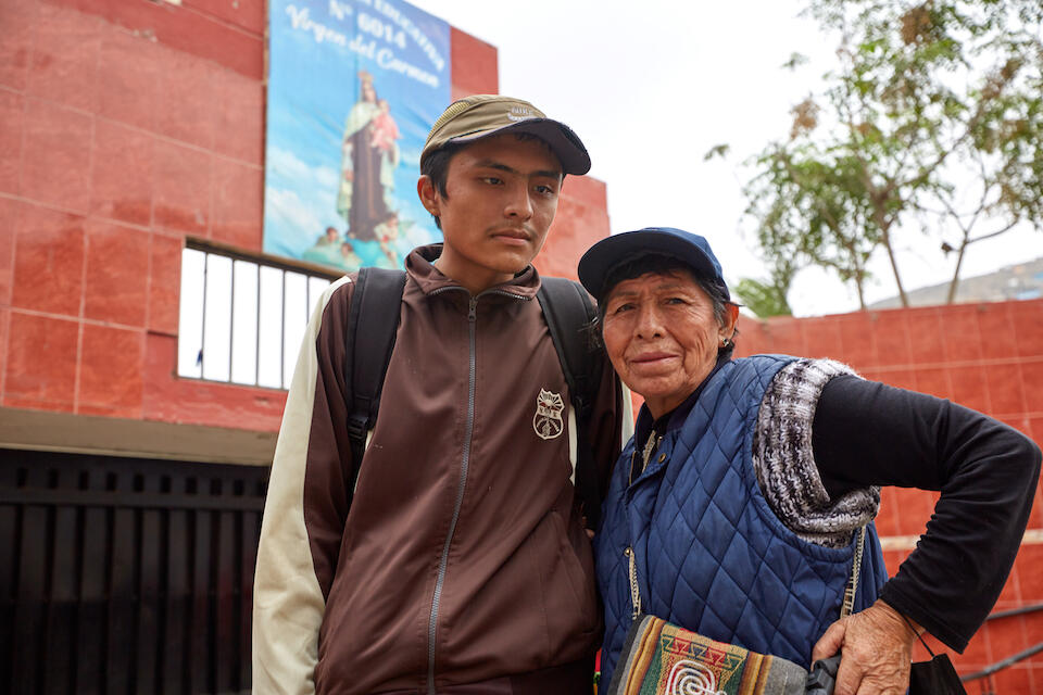 In Peru, 14-year-old Joel, who has autism, stands with his grandma, tutor and mentor, Celestina. 