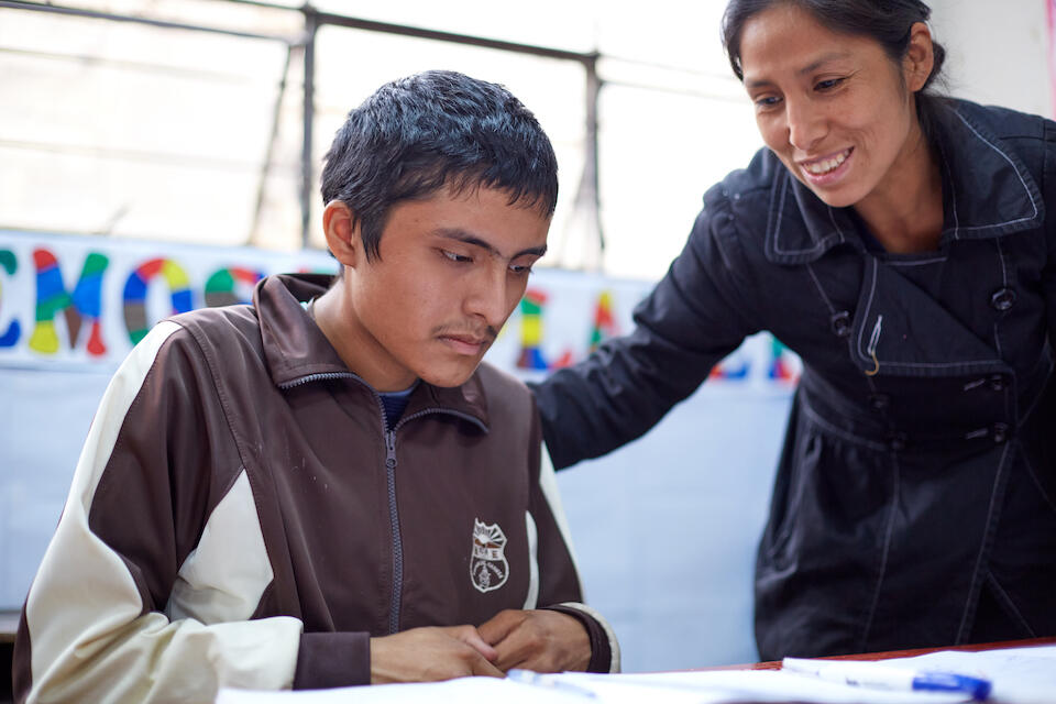 Joel, who has autism, works with a teacher at UNICEF-supported Virgen del Carmen School in Peru. 