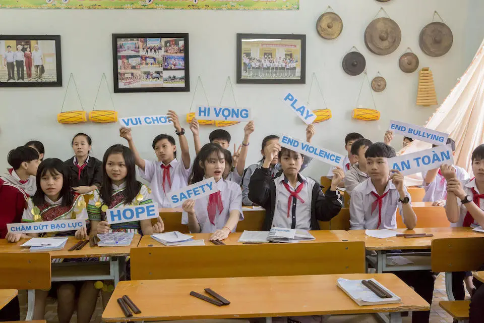 At a World Children's Day celebration, students at a UNICEF-supported school in Vietnam hold up signs showing some of their hopes for the future.