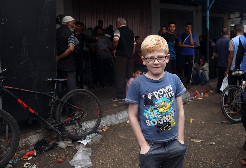 On Nov. 3, 2023, 10-year-old Kenan waits patiently in a long line for bread at a bakery in Gaza City.