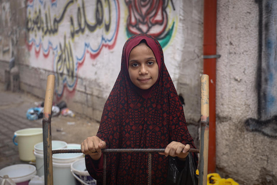 On Nov. 3, 2023 in the Gaza Strip, Mariam uses a cart to fetch drinking water for her family. 