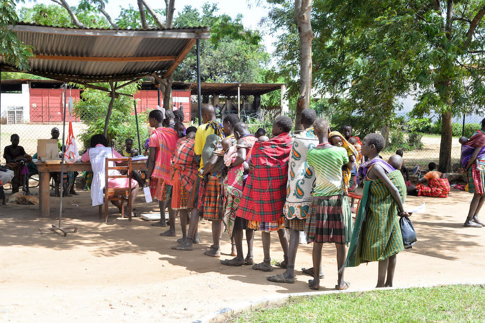 Mothers with their children line up for nutrition screening and treatment at  Loputuk Health Center III in Moroto District, Karamoja Sub Region, Uganda..