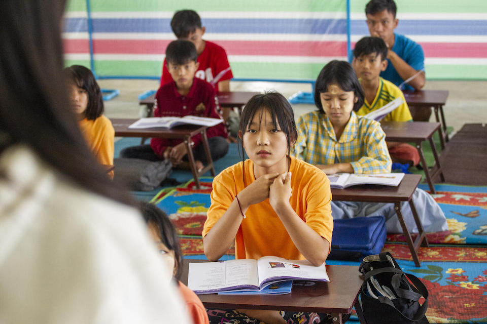 Thae, 14, listens attentively to her teacher during class held at a UNICEF-supported learning center for displaced children at Myoma Yangon monastery, Nyaung Shwe, Shan State.