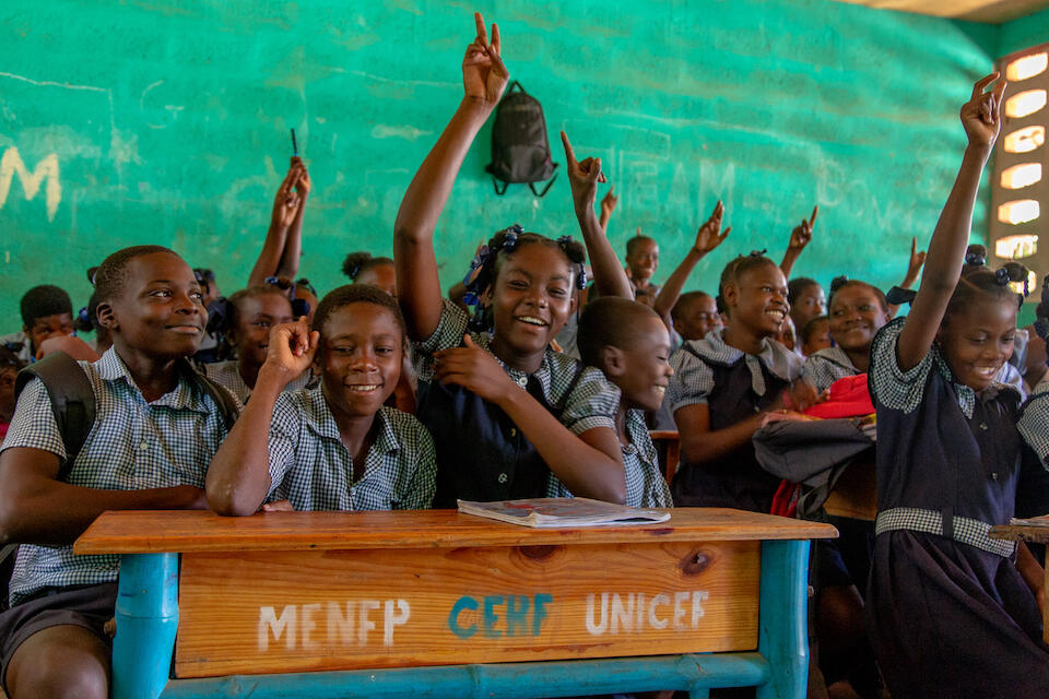 Schoolchildren in Haiti's Grand'Anse department sit at their desks with learning materials and school supplies provided by UNICEF. 