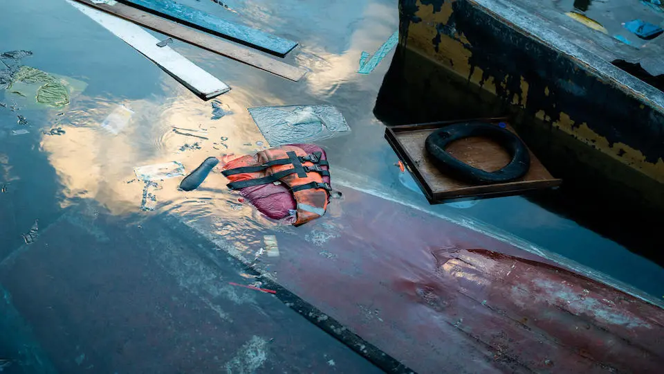 A life jacket floats near a sinking boat at Favaloro pier in Lampedusa Italy on Sept. 26, 2023.