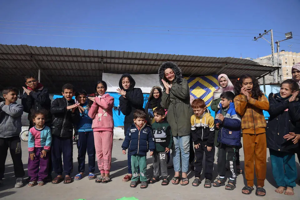 UNICEF leads recreational activities for children in the courtyard of a shelter in Gaza.