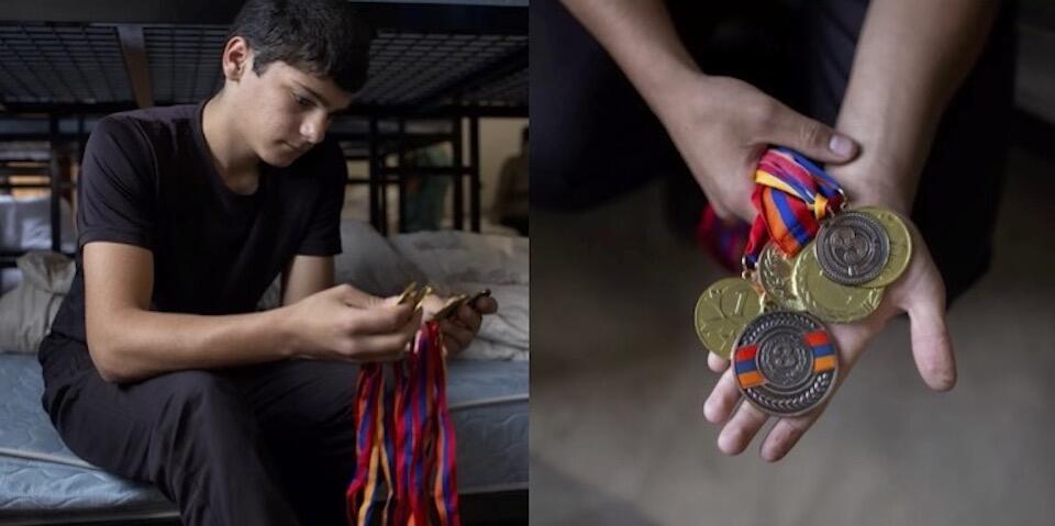 Eduard, 15, looks at his karate medals and wonders whether he will be able to continue his practice living as a refugee in Armenia.