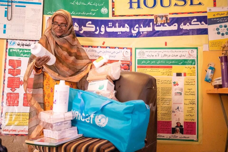 A Lady Health Worker examines the contents of her supply kit, provided by UNICEF and partners, in Hyderabad, Sindh, Pakistan.