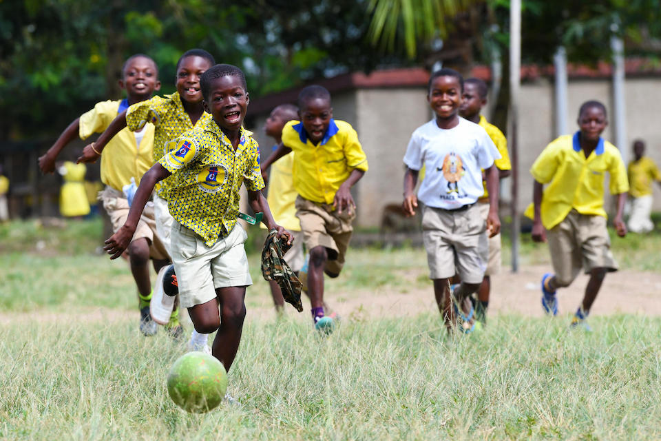 Boys playing football outside Asuokaw Methodist School in eastern Ghana.