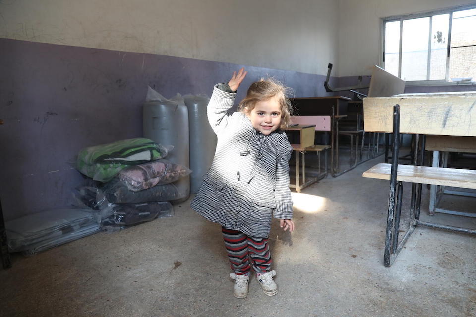 A child takes refuge in a school turned into a temporary shelter for people affected by the earthquake in Jandairis, northern Syria, in the Afrin District of the Aleppo Governorate.