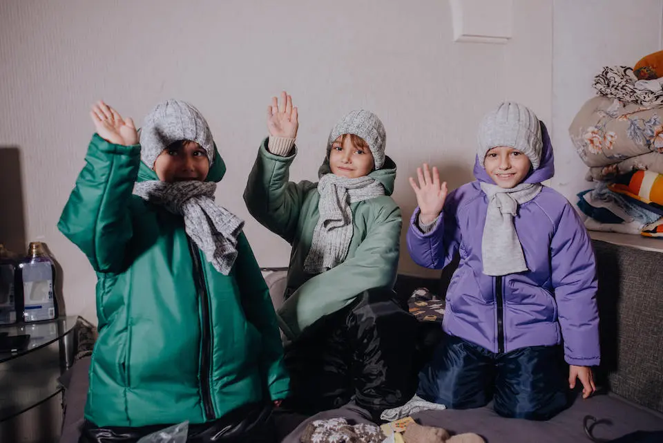 In Odesa, Ukraine, brothers try on new sets of clothes, provided by UNICEF.