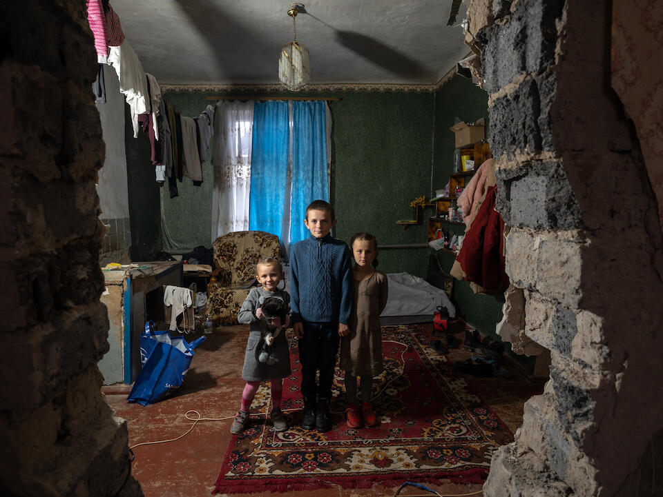 Children stand in their home, damaged by a rocket, in Izium, Kharkivska oblast, Ukraine.
