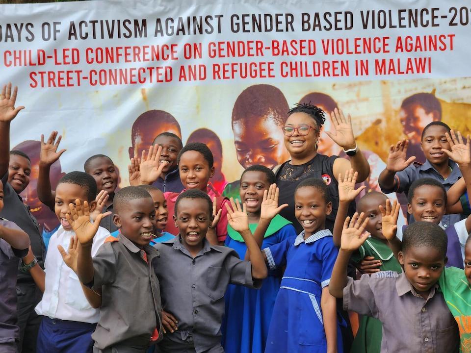 Children and young adolescents pose in front of a Stop GBV (gender-based violence) sign on Nov. 30,  2023 at Sunbird Lilongwe Hotel in Lilongwe, Malawi during a UNICEF Child Led Conference. 