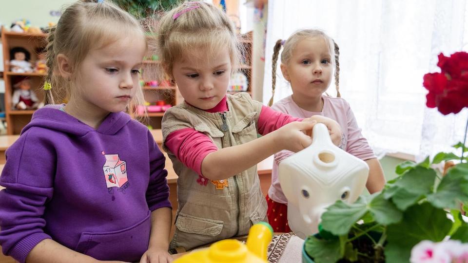 Children water the plants in their classroom in Vasylkiv, Ukraine. UNICEF recently financed the repair of local water and sanitation systems. 