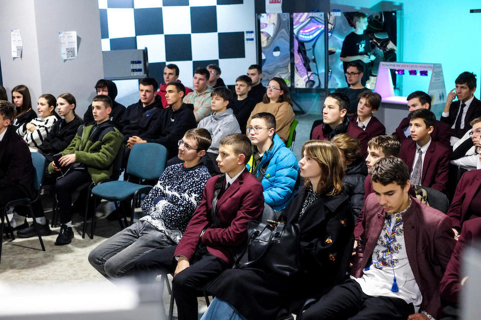 On Dec. 14, 2023, in Ivano-Frankivsk, Ukraine, young people listen attentively to a sustainability presentation organized by a UNICEF UPSHIFT tea