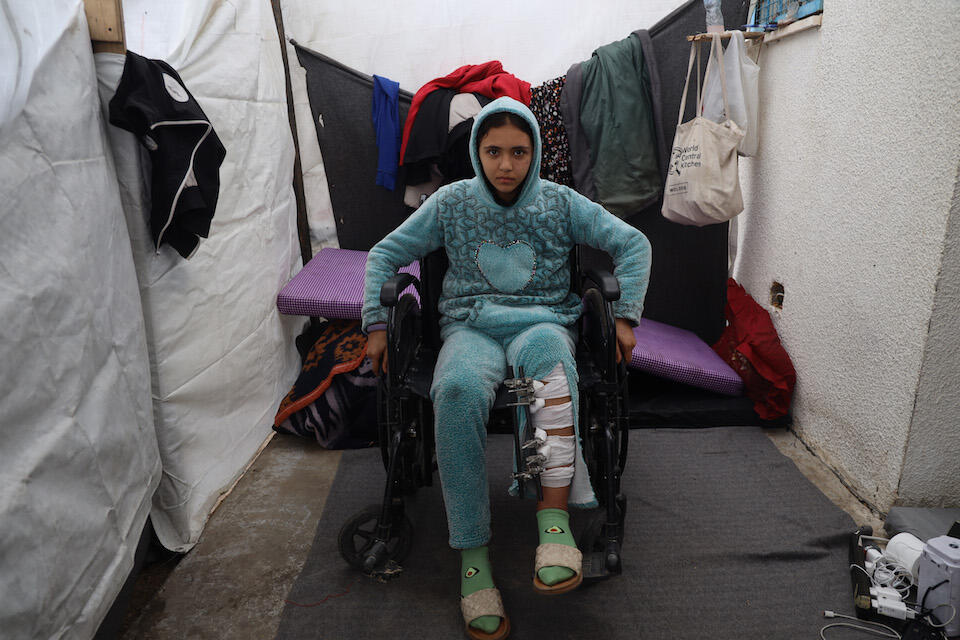 On Jan. 11, 2024, Mays, 13, sits in a wheelchair in a shelter center located in Khan Yunis's industrial zone, southern Gaza. 