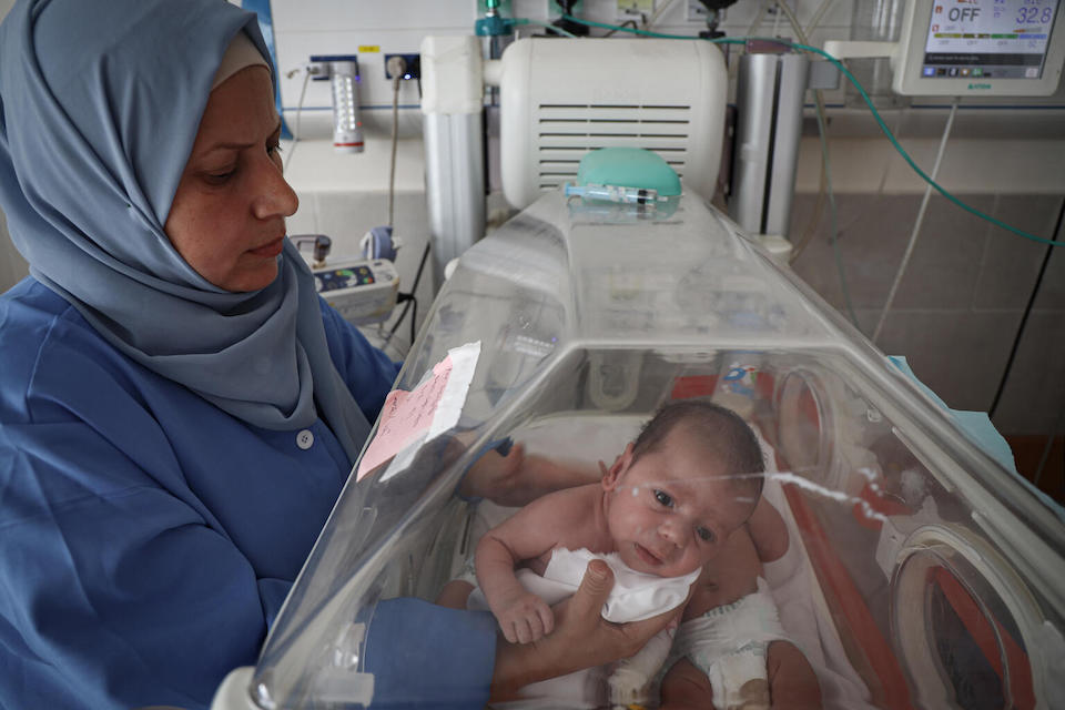 On Jan. 12, 2024, a nurse cares for newborn babies who are being kept inside an incubator at UNICEF-supported Emirati Maternity Hospital in Rafah in the southern Gaza Strip.