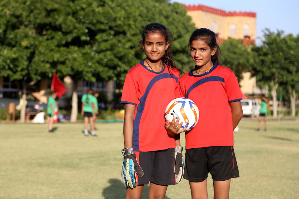 In Ajmer district, Rajasthan, India, Gayatri,18, and her sister Savitri , 15, pause during a practice session for a UNICEF-supported girls’ soccer initiative to tackle gender inequality.