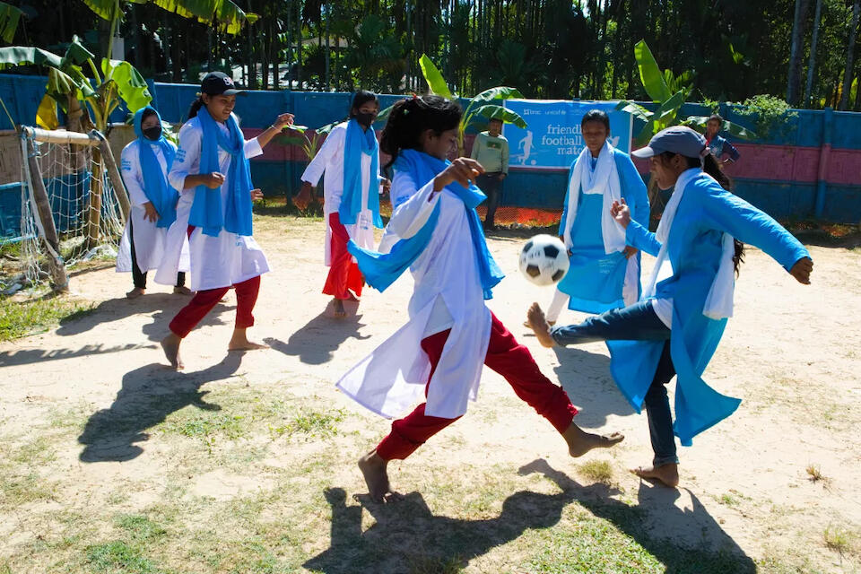 Fifteen-year-old Ruma, left, a Rohingya refugee, is a great footballer and a popular player at the UNICEF-supported social hub where Rohingya girls and Bangladeshi girls spend time together.