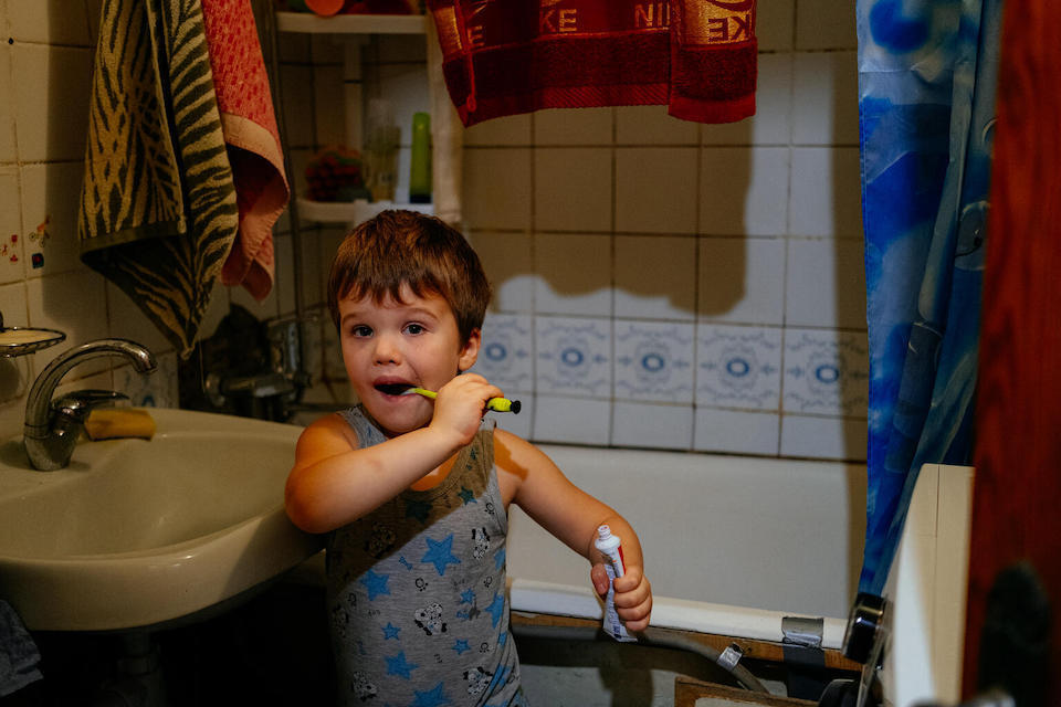 Artem, 5, of Kharkhiv, Ukraine, is back to brushing his teeth at the bathroom sink now that the household water supply has been restored, with UNICEF's help.