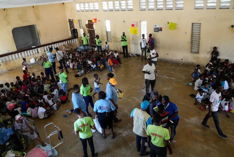 Displaced children sit on the floor of a UNICEF-staffed and -supported nutrition site in Delmas, a commune in the Port-au-Prince metro area.