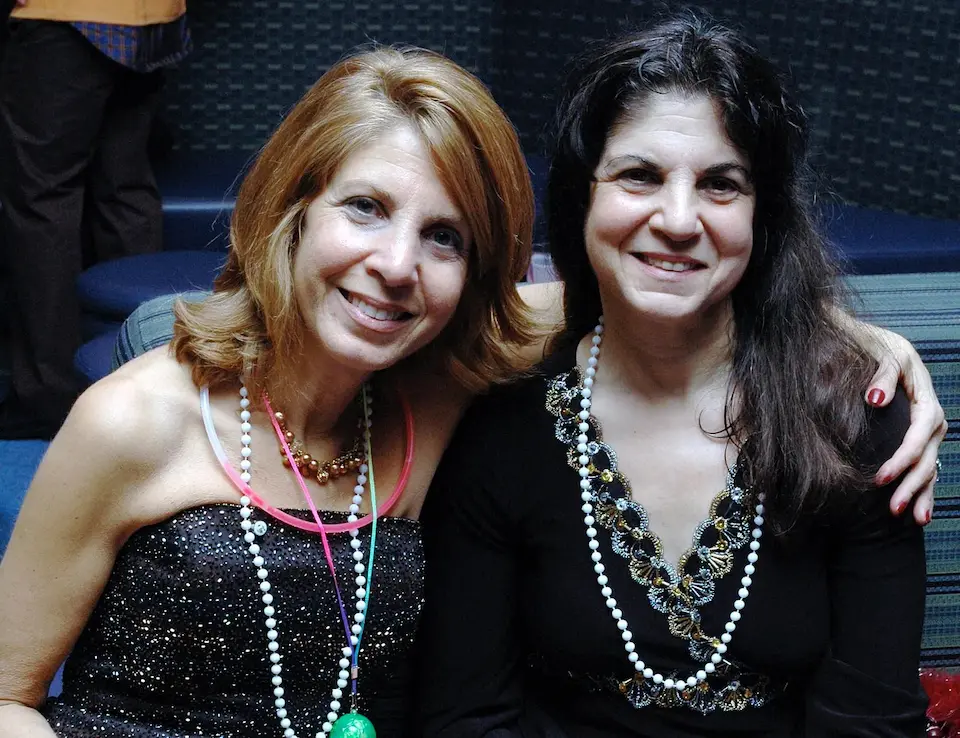 Emmi Herman (left), with her sister, who suffered a permanent brain injury after contracting measles at age 9.