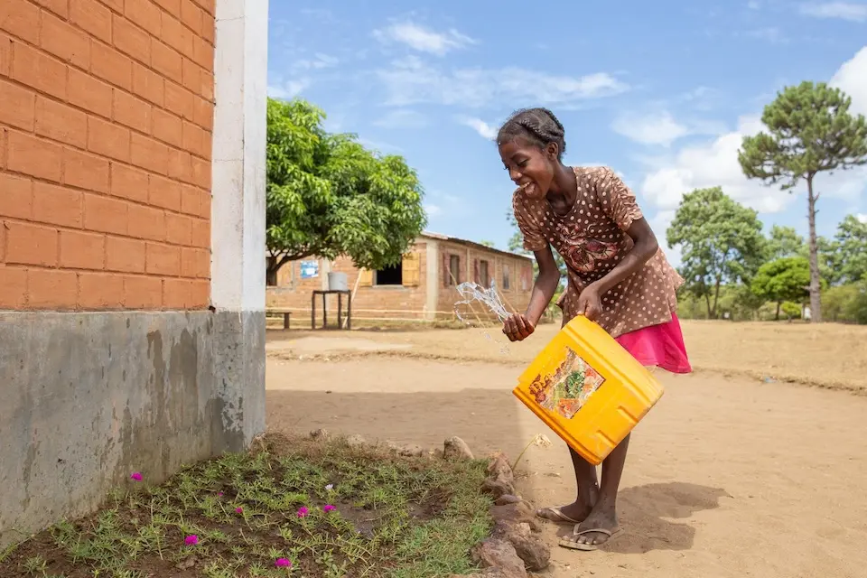 A girl waters the garden outside a primary school in Ifanjahira, Madagascar.