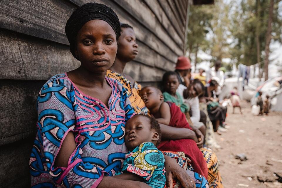 Mahombi waits to have her 16-month-old daughter, Baraka, screened for malnutrition at the UNICEF-supported Kanyaruchinya IDP site in North Kivu province, DR Congo, on March 8, 2024.