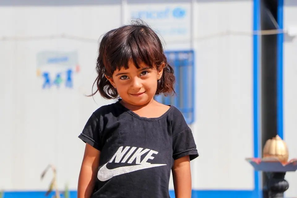 Sahar, 3, stands outside the UNICEF -supported early childhood education center called 'Dream' in Ain Khadra camp in Al-Malikiyeh, Al-Hasakeh, Syria, on Sept. 21, 2023.