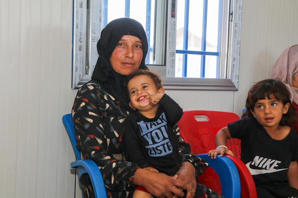 Sahar, 3, sits next to her mother, Zalkha, at a UNICEF -supported early childhood education center in Ain Khadra IDP camp in Al-Malikiyeh, Al-Hasakeh, Syria, on Sept. 21, 2023.