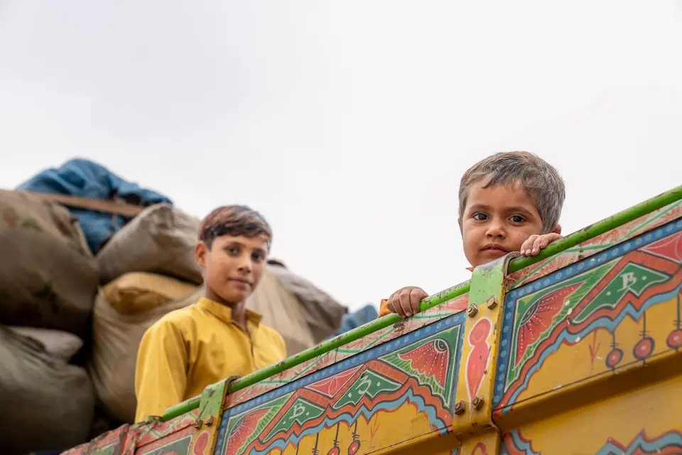 On Nov. 7, 2023, two boys sit in the back of a truck at Afghanistan's Torkham border with Pakistan in eastern Nangarhar province.