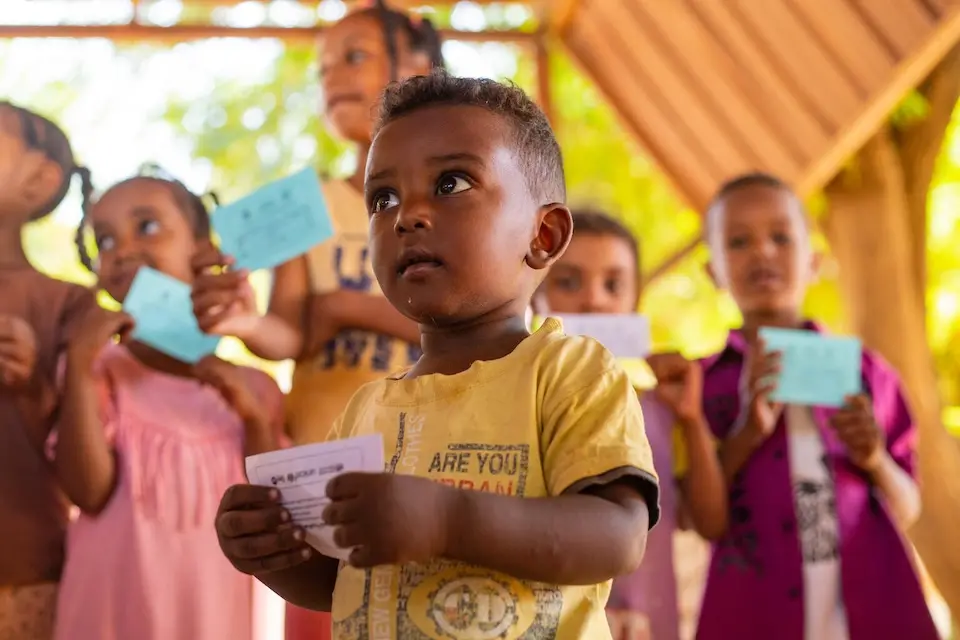 On Nov. 21, 2023, children hold vaccination cards after receiving doses of cholera vaccine during a cholera vaccination campaign in Madani, Gezira State, Sudan.
