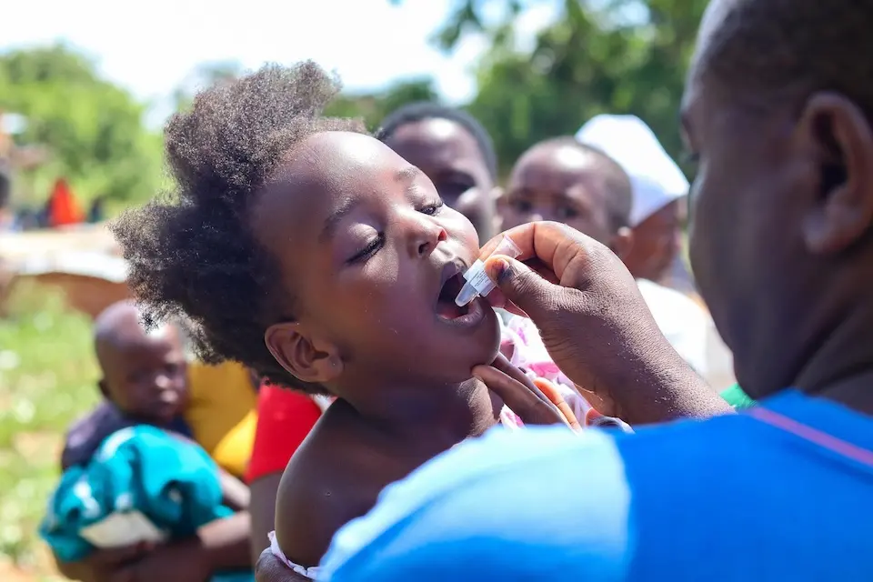 A child in Buhera district, Manicaland province, Zimbabwe, receives an oral cholera vaccine as part of a UNICEF-supported immunization campaign.