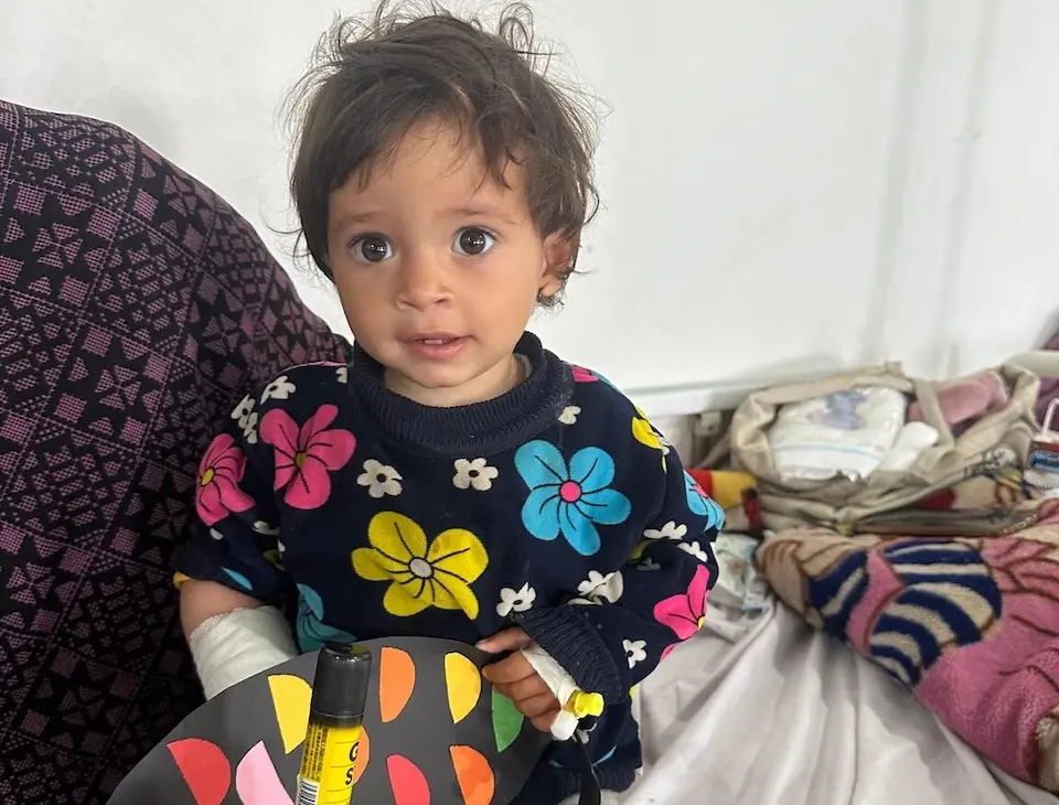 On April 7, 2024 at the Rafah Indonesian Field Hospital in southern Gaza, a small child watches as members of UNICEF partner organization Tamer tell stories and lead arts and crafts projects as part of Mental Health and Psychosocial Support (MHPSS) programming for children injured in the conflict.