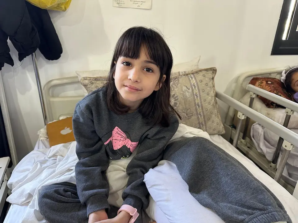 On April 7, 2024, 9-year-old Raghad sits up in bed at the Rafah Indonesian Field Hospital in southern Gaza, where UNICEF and its partner Tamer conduct Mental Health and Psychosocial Support (MHPSS) sessions for children injured in the conflict.