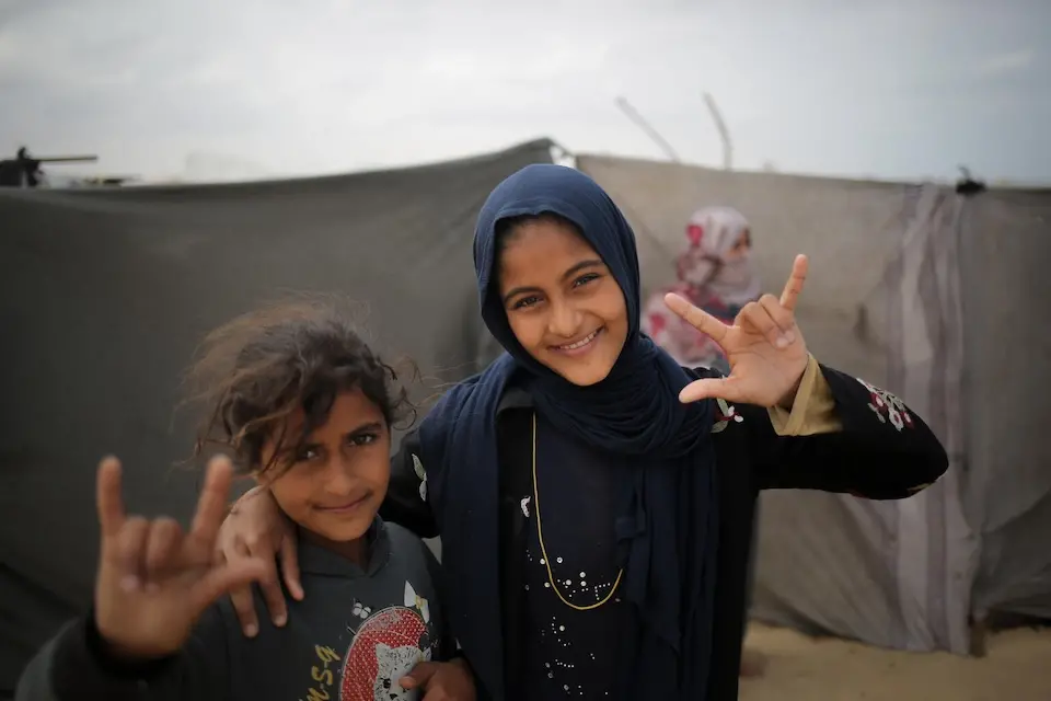 Fourteen-year-old Duha, right is a deaf girl originally from Beit Hanon, northern Gaza Strip and now displaced in Rafah, southern Gaza.