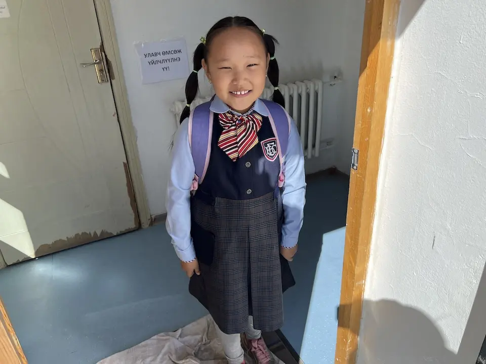 A young girl in Mongolia heads off to school.