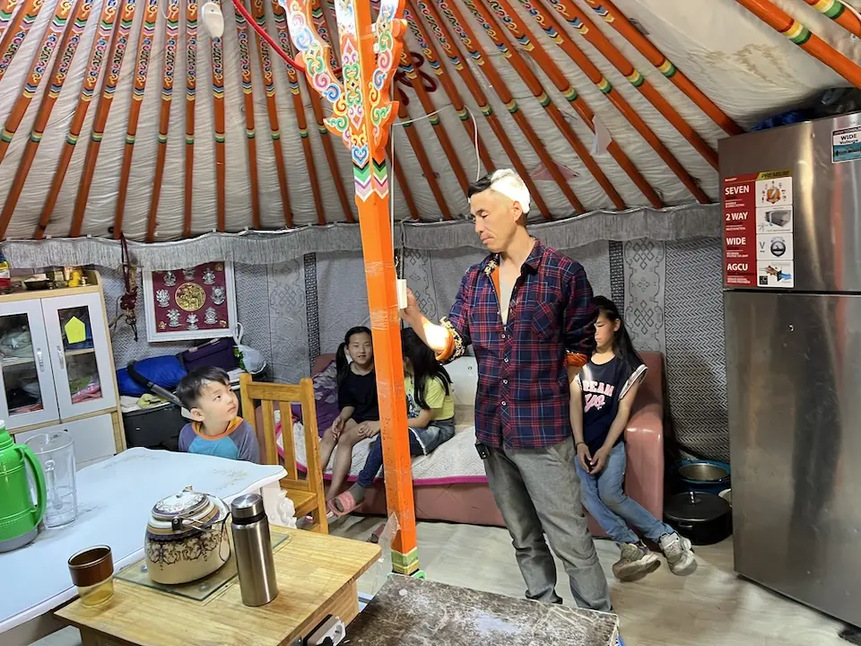 As his son and a few neighbors look on, a father adjusts the settings on his "CHIP"unit — a clean energy solution for cooking, heating and insulating a traditional ger home that UNICEF and partners have introduced in Mongolia to help curb air pollution and reduce associated health risks for children in the country.