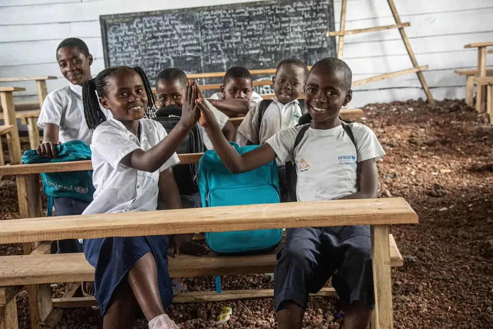 10-year-old Adili (left) and Amuli (right) sit in class at the Bujari primary school, in Nyiragongo territory, in the North Kivu province of DR Congo.