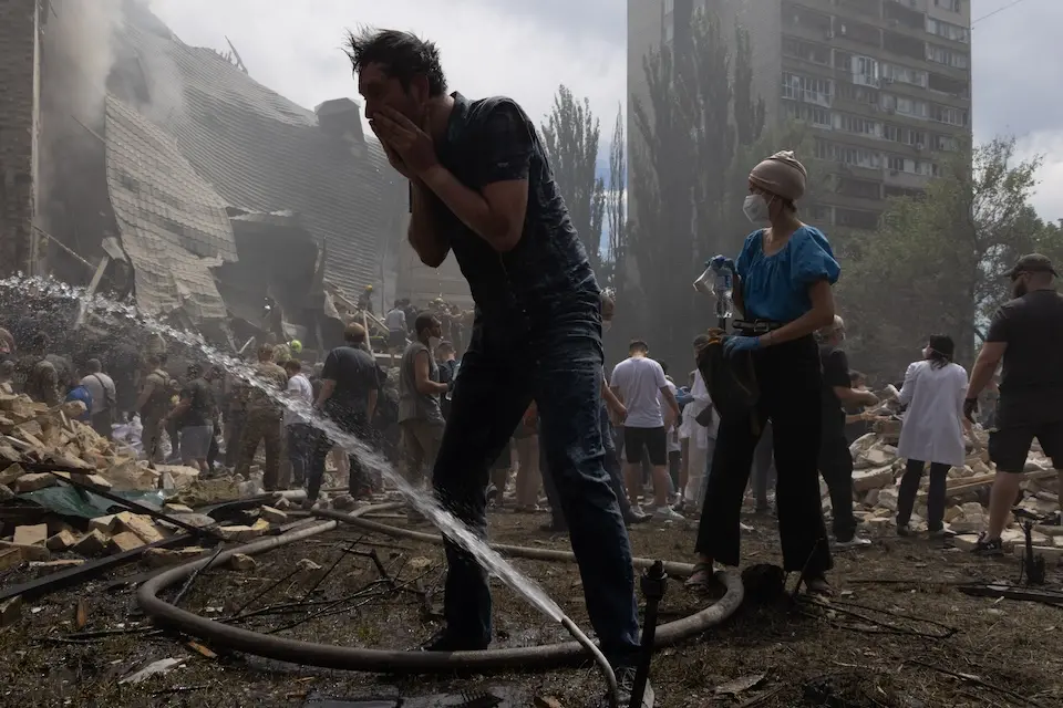 On July 8, 2024 in Kyiv, rescuers, hospital staff and volunteers clear rubble and search for people trapped under debris after an attack that hit Okhmatdyt Hospital, Ukraine's largest children's medical center.