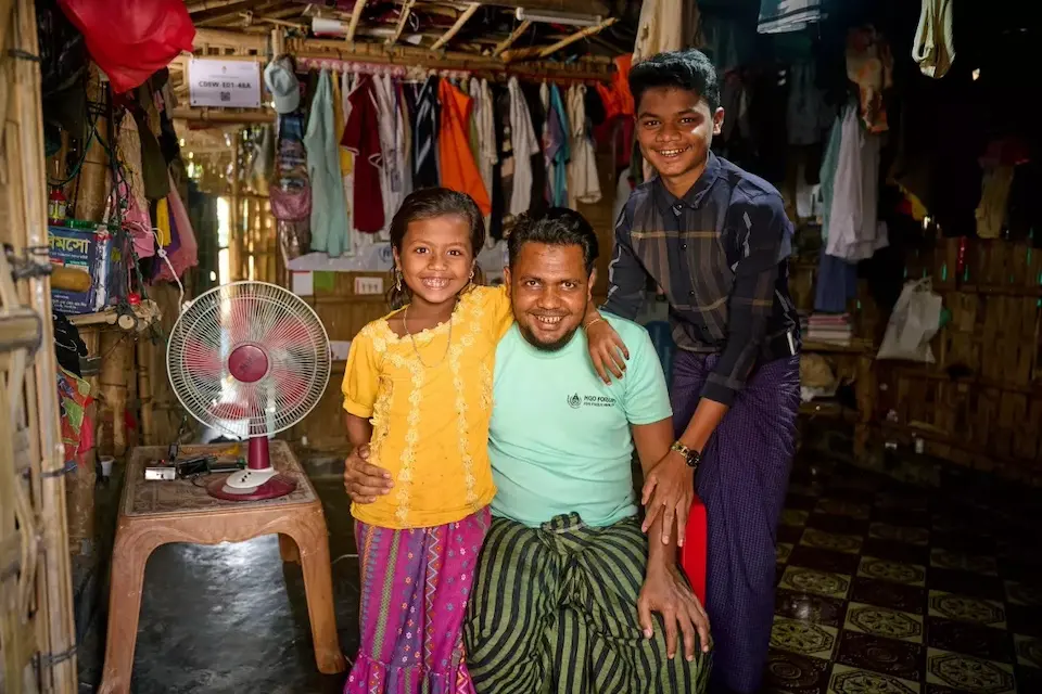 Anayet with his father and younger sister at their home in the Rohingya refugee camp.