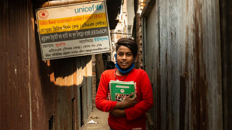 Arif (12) stands in front of the Ability Based Accelerated Learning (ABAL) center where he is enrolled in Bangladesh. ©️ UNICEF/UN0393280/Satu